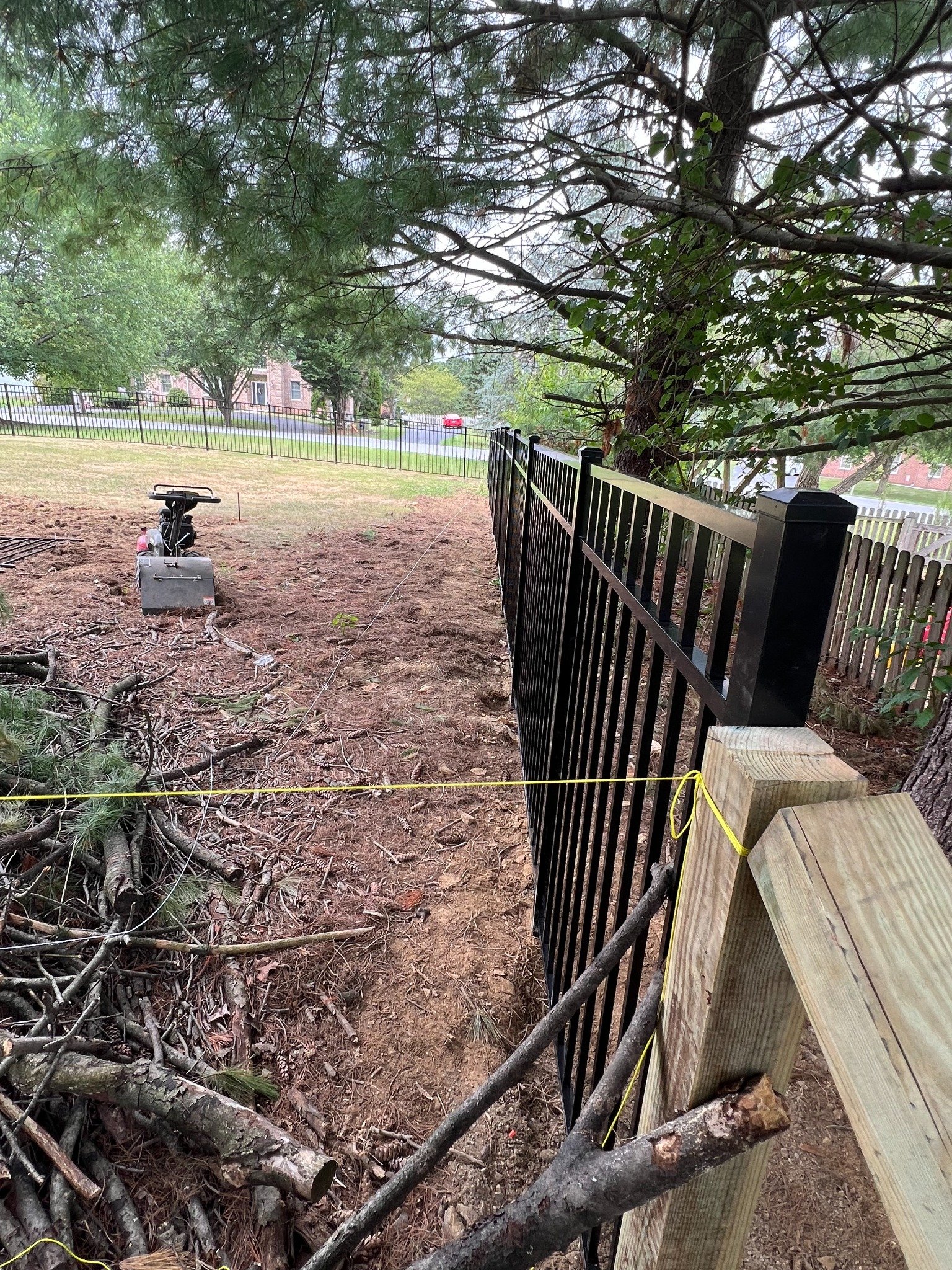 Black metal fence layout and site preparation